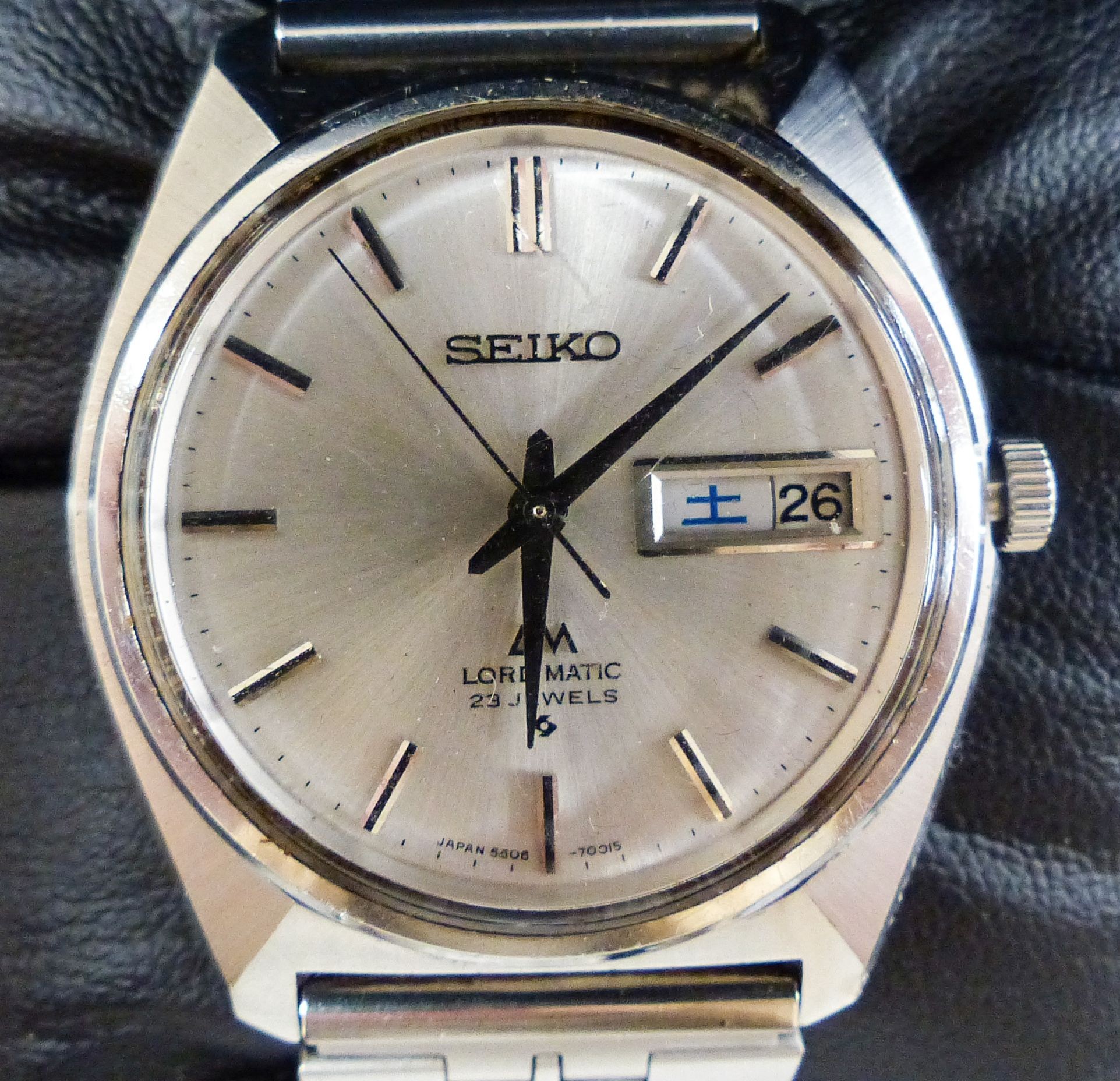 A gentleman's 1980's stainless steel Seiko Lord Matic day date wrist watch, on associated strap, model 5606 7000, cased diameter 36mm, with Seiko box.